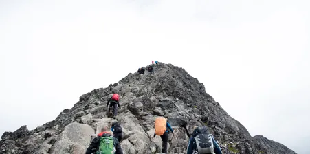Hikers climbing up peak in Besseggen, Norway