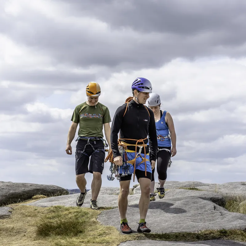 climbing guide leading two climbers across rock