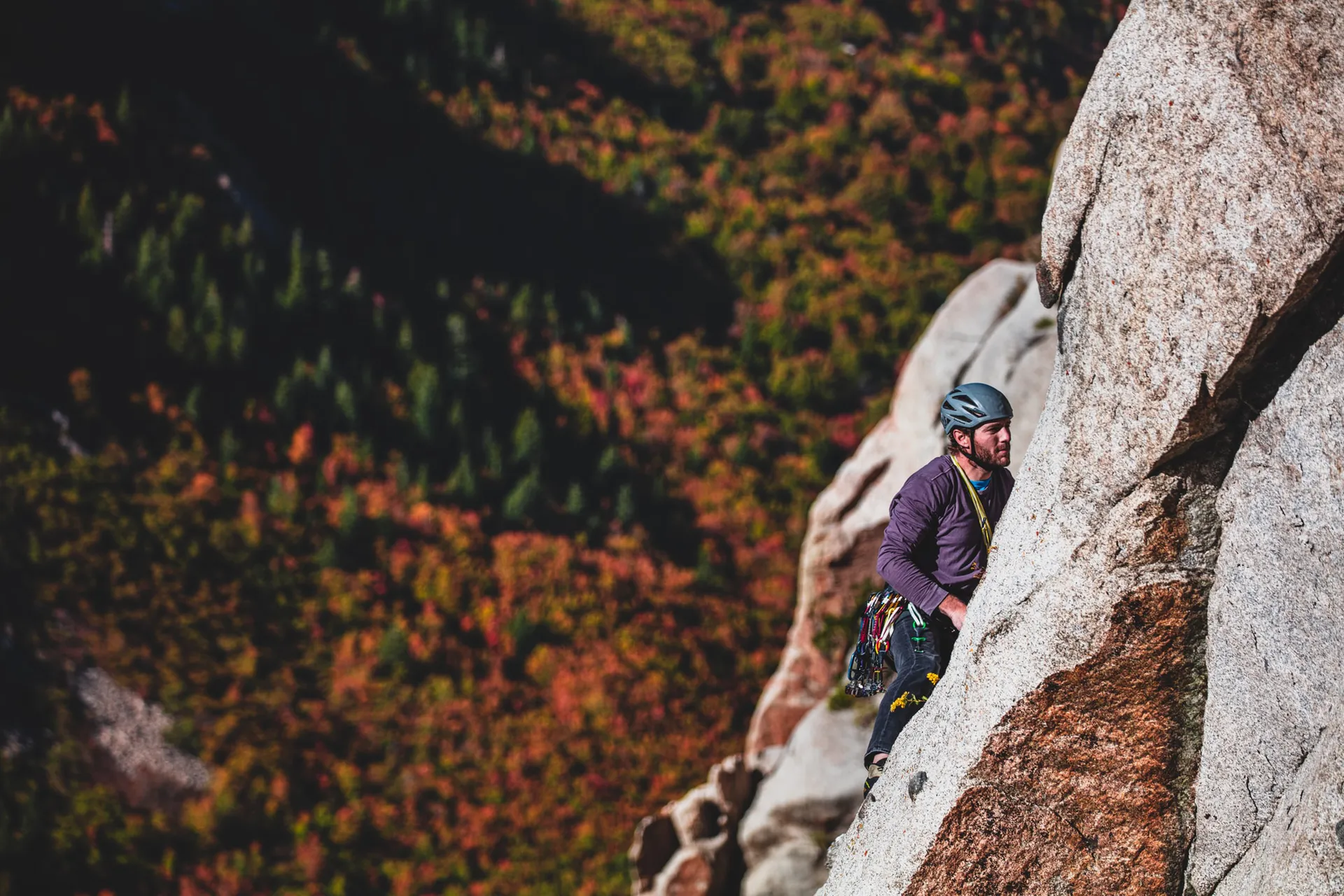 man climbing a steep rock face
